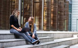 women sitting on steps