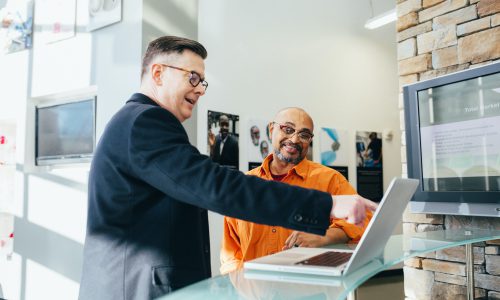 men looking at laptop