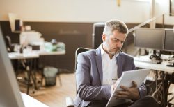 man writing on notepad